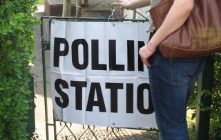 image of someone standing at the entrance of a polling station