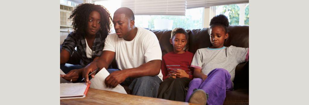A family sitting on a sofa