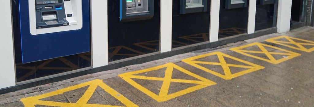 An ATM machine with security markings.