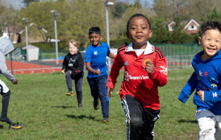 young children running in a park