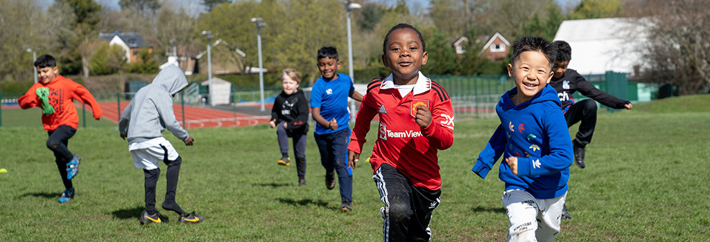 young children running in a park
