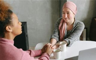 A picture of two people talking to each other and holding hands.