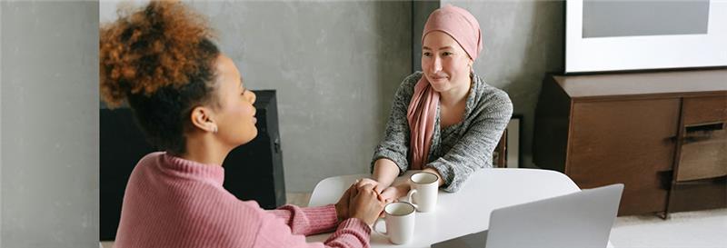 A picture of two people talking to each other and holding hands.