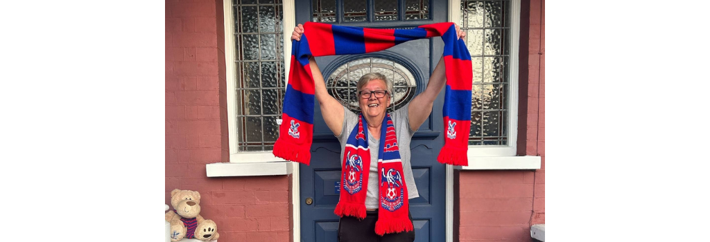 Photo of Debbie Bentley-Ross holding a CPFC scarf