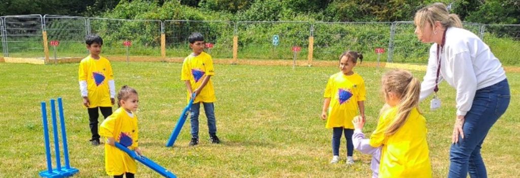 Photo of children playing cricket.
