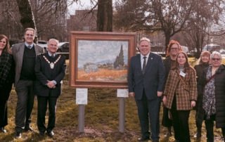 Mayor Perry, the Civic Mayor, the Director of the National Gallery and residents stand in Queen's Gardens in front of the Van Gogh's Sunflowers in the Art on Your Doorstep exhibition.