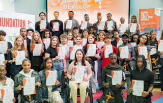 Around 50 young local athletes gather in Ashburton Hall with their award certificates.