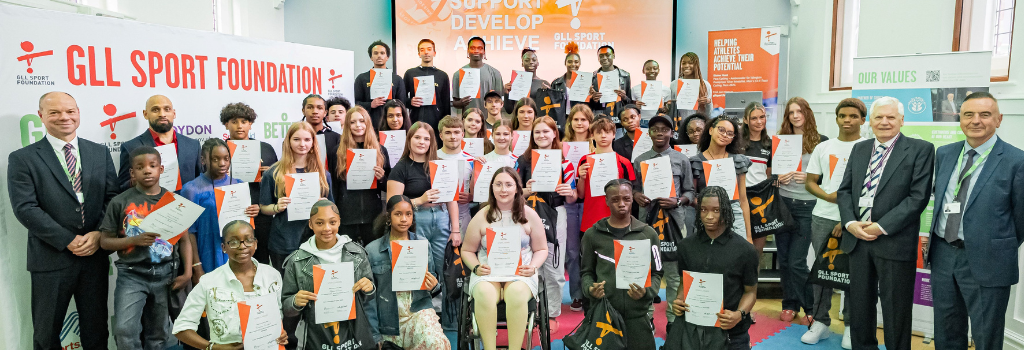 Around 50 young local athletes gather in Ashburton Hall with their award certificates.