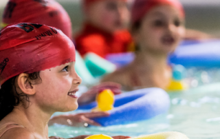 A young girl enjoying a swimming lesson at a Better leisure centre.