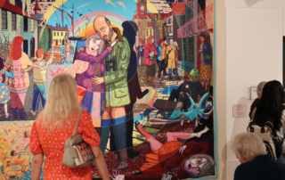 Visitors to the Museum of Croydon admiring one of Grayson Perry's tapestries.